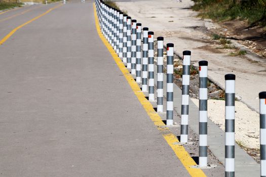 fence posts on the pedestrian sidewalk close-up