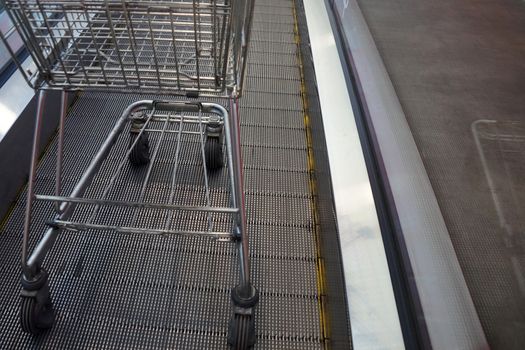 empty trolley on supermarket escalator