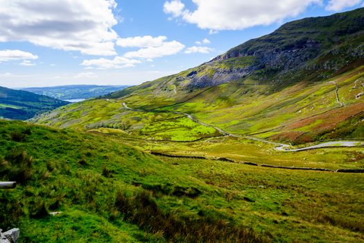 The Struggle road at Kirkstone Pass leading to Windermere lake Ambleside with Snarker Pike of Red Screes mountain on right in Lake District England