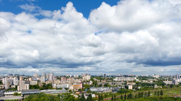 Large gray and white clouds loomed over Kyiv's residential areas, green parks and a television tower.