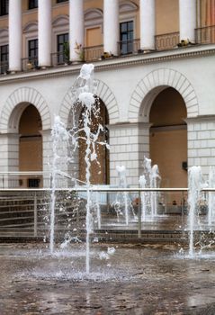 The city fountain adorns the center of the city with beautiful splashes of a water carousel against the background of the arched and columned facade of the Kyiv City Conservatory.