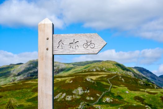 wooden public bridleway sign post on Kirkstone Pass in The Lake District