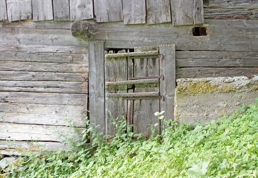 Door in a very old cabin in Switzerland, not in use anymore