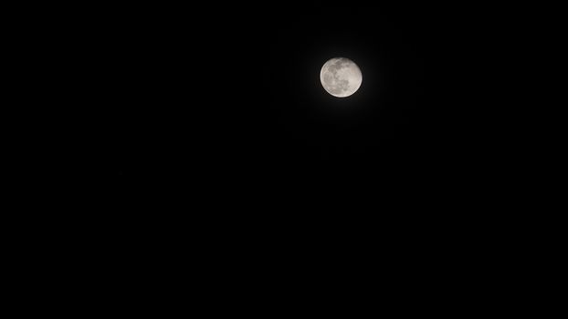 Moon with color on the dark sky at night and isolated black background.