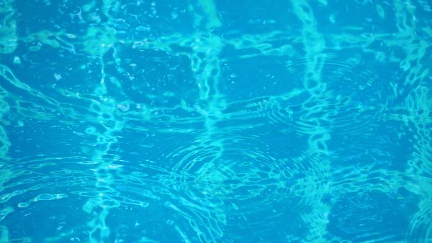 Rain drop falling on pool and have ripple shape and sun light reflection on surface for abstract background. 