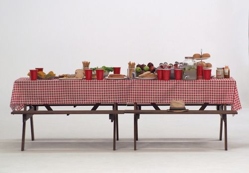 Wood table and red napkin cover for outdoor party or picnic in the garden for summer season and white background.