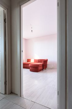 Entrance to an empty bedroom with an old sofa