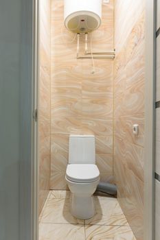 Small compact toilet, there is a water heater upstairs