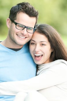 Portrait of young happy couple spending time together outdoor. Man and woman laughing and having fun. Love and romantic relationships. Harmony and happiness in family life.