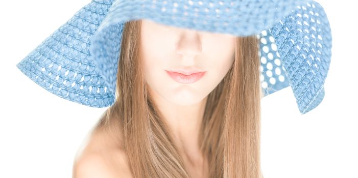 Portrait of pretty girl with her eyes under blue crocheted hat isolated on white background. Half hidden beautiful face. Woman beauty and mystery. Shy and modest.