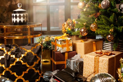 Christmas tree decorated with gold balls. Under the Christmas tree a large number of Christmas gifts. Christmas holiday concept. A huge number of gift boxes under Holiday background