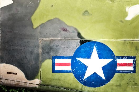 Part of military airplane with United States Air Force sign. Big white star in blue circle with stripes aside. War aircraft in metal plates. Military aviation. Retro style. Safety and protection.