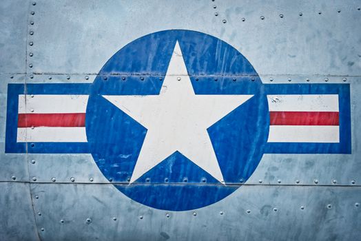Part of military airplane with United States Air Force sign. Big white star in blue circle with stripes aside. War aircraft in metal plates. Military aviation. Retro style. Safety and protection.