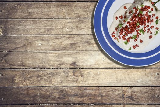 Top view of chiles en nogada, traditional festive dish on Mexican Independence Day. Green chili peppers with walnut sauce, common food for Mexico, in celebrations and national holidays. Copy Space