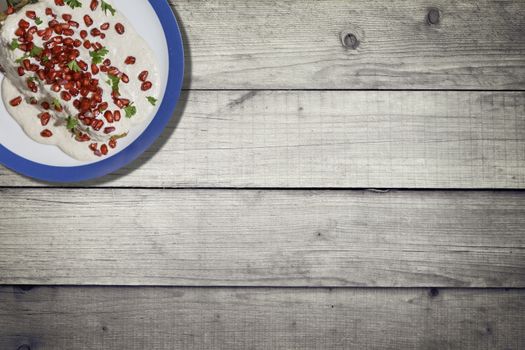 Top view of chiles en nogada, traditional festive dish on Mexican Independence Day. Green chili peppers with walnut sauce, common food for Mexico, in celebrations and national holidays. Copy Space