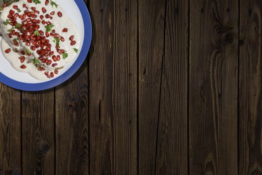 Top view of chiles en nogada, traditional festive dish on Mexican Independence Day. Green chili peppers with walnut sauce, common food for Mexico, in celebrations and national holidays. Copy Space