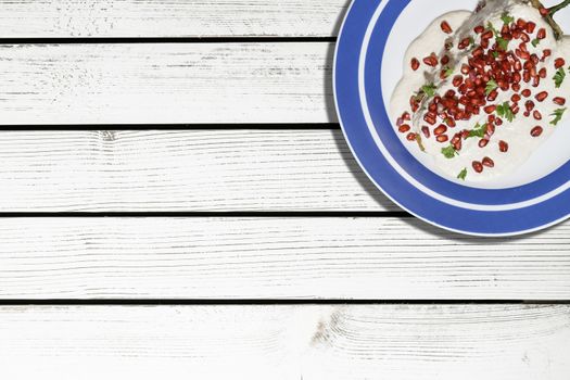 Top view of chiles en nogada, traditional festive dish on Mexican Independence Day. Green chili peppers with walnut sauce, common food for Mexico, in celebrations and national holidays. Copy Space