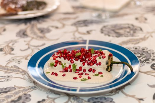 Chile en nogada, traditional festive dish on Mexican Independence Day. Green chili peppers with walnut sauce. National holidays