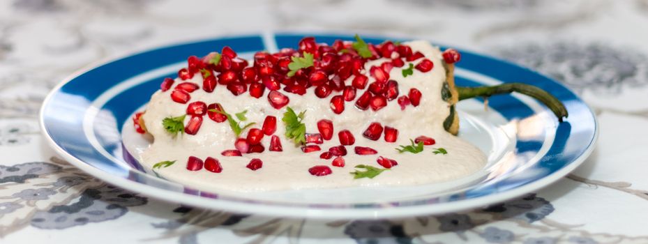 Chile en nogada, traditional festive dish on Mexican Independence Day. Green chili peppers with walnut sauce. National holidays