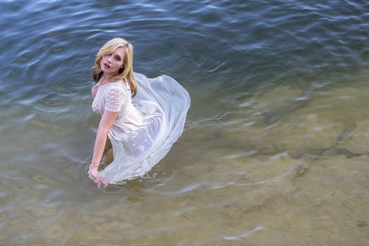 A gorgeous blonde model enjoys the lake on a summers day