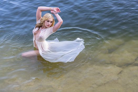 A gorgeous blonde model enjoys the lake on a summers day