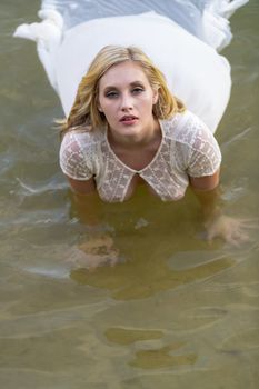 A gorgeous blonde model enjoys the lake on a summers day