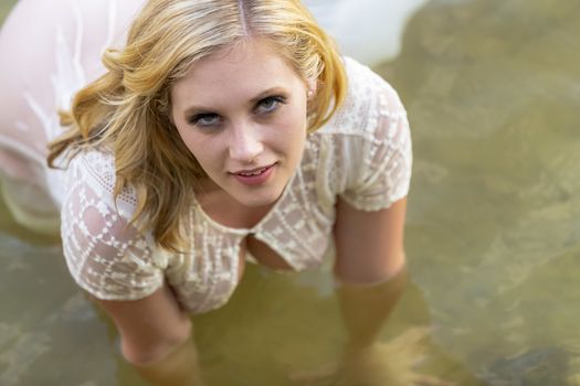 A gorgeous blonde model enjoys the lake on a summers day