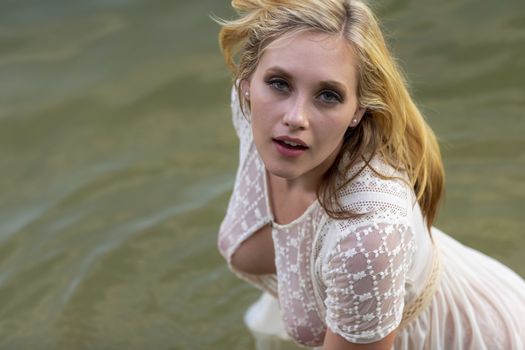 A gorgeous blonde model enjoys the lake on a summers day