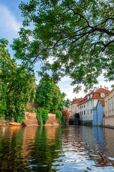 The architecture of the strago city of Prague. River channel in the city. Streets of old Europe, cityscape.