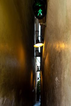 The architecture of the strago city of Prague. The narrowest street in Europe. The passage between buildings for one person, regulated by traffic lights.