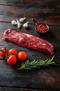 Machete steak raw cut or hanging tende cut, with rosemary over wood background Top side view.