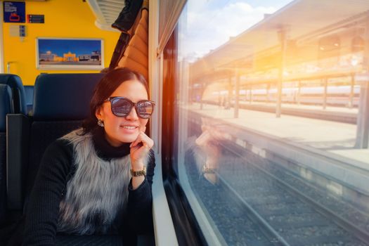 Young woman traveling looking view while sitting in the train.