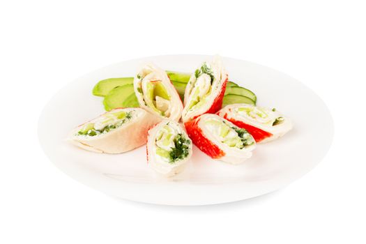 Crab sticks cut meat rolls with vegetables avocado cucumbers sauce on plate isolated on white background