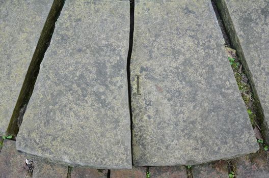 damaged grey stone or rock tile saying I with bricks or masonry