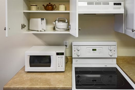 Open cabinets and primary appliances on average home kitchen
