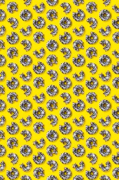 donuts on a yellow background top view. Flat lay of delicious nibbled chocolate donuts. used as donut banner or poster background, not pattern