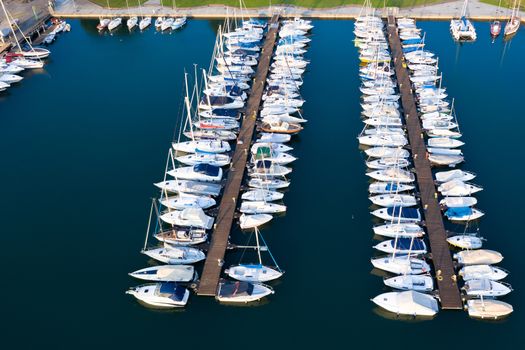 Aerial bird eye view of sailboats and yachts moored in Lovere port, Iseo lake near Bergamo,Italy.