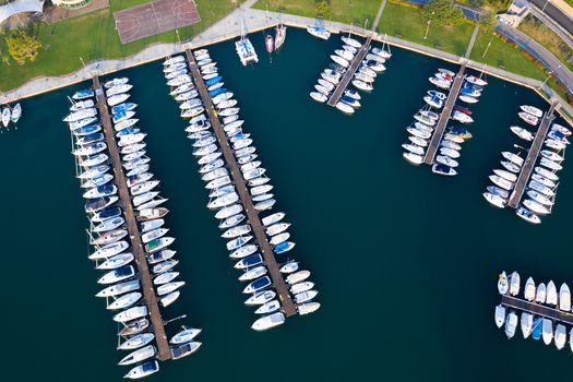 Aerial bird eye view of sailboats and yachts moored in Lovere port, Iseo lake near Bergamo,Italy.