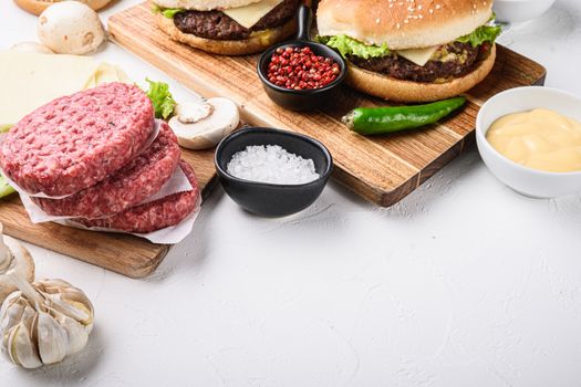 Burger with beef for grill on white background with copy space.