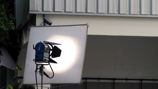 Big studio lighting with tripod for video production and outdoor location movie shooting.