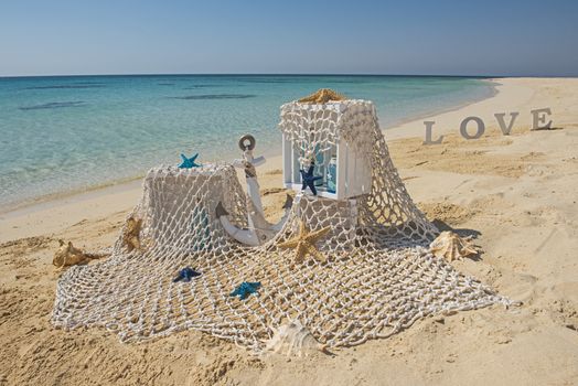Closeup of wedding romantic decorations on tropical island sandy beach paradise with ocean in background