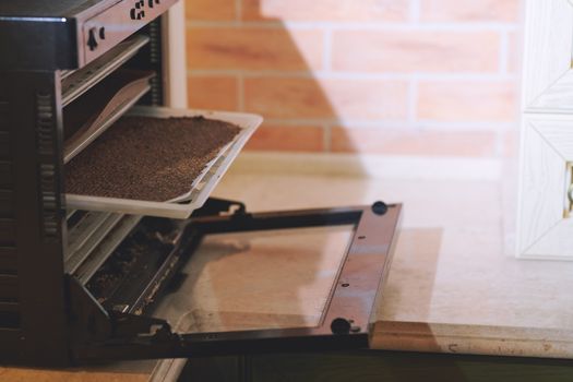 Modern oven with flaxseeds to be dried