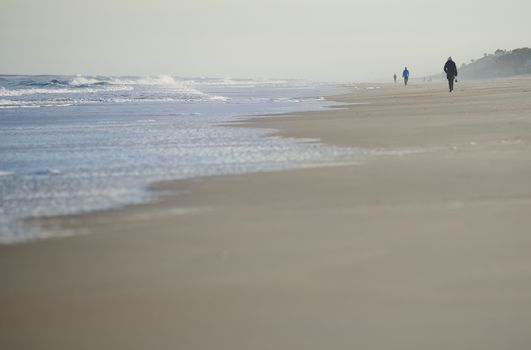 Incidental people walking along the beach of Atlantic Ocean. USA