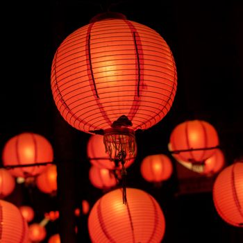 Beautiful round red lantern hanging on old traditional street, concept of Chinese lunar new year festival in Taiwan, close up. The undering word means blessing.
