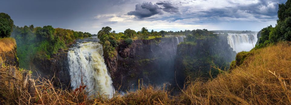 Panorama of Victoria Falls on Zambezi River located at the border of Zambia and Zimbabwe, the largest waterfall in the world.