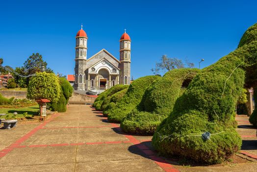 Catholic church called Iglesia de San Rafael and its park in Zarcero, Costa Rica
