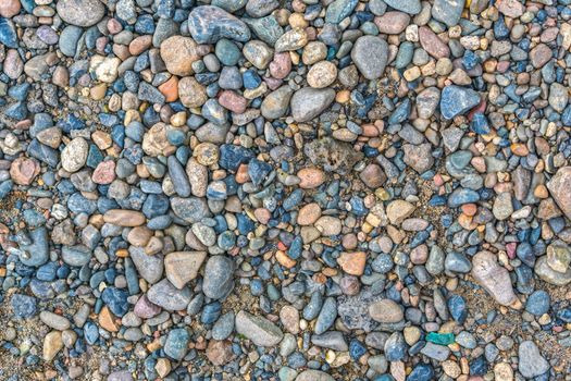 River pebbles mixed with sand as background or texture