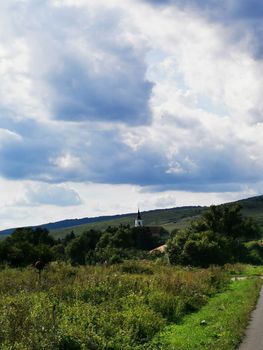 Near Aggtelek church and overged sky High quality photo