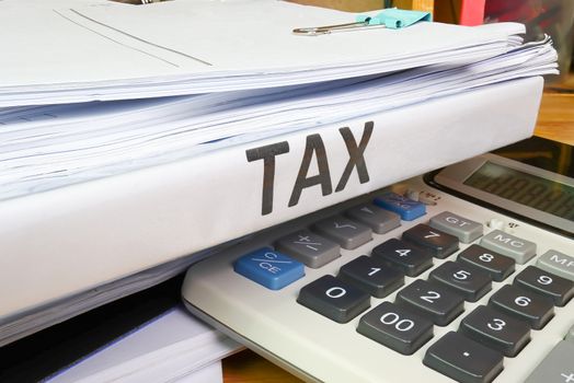 Folder Tax documents and paper files with calculator concept Annual tax payment