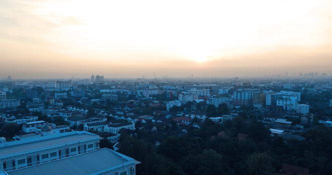 Sun rise on the sky and Bangkok urban city landscape in the morning.